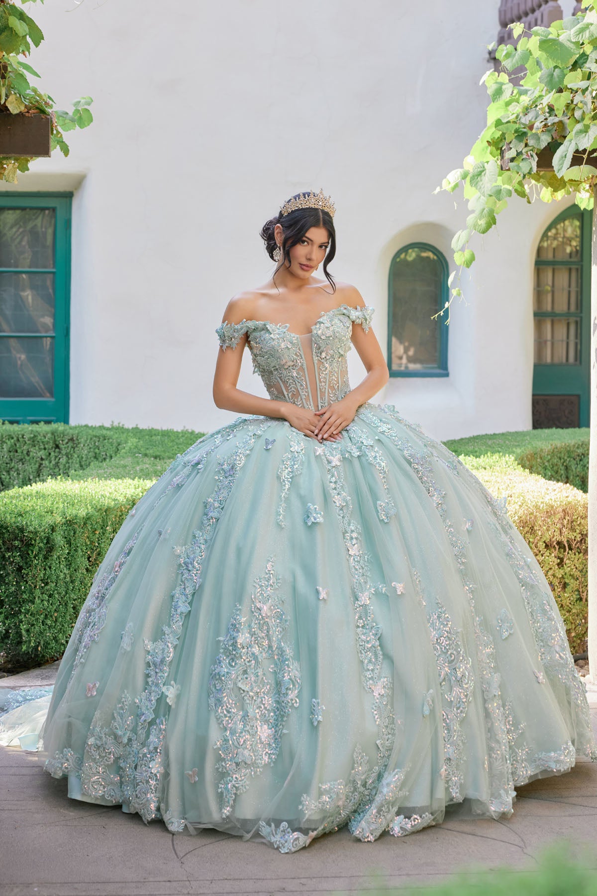 Off-shoulder corset bodice adorned with ornate embroidery and shimmering appliqués.