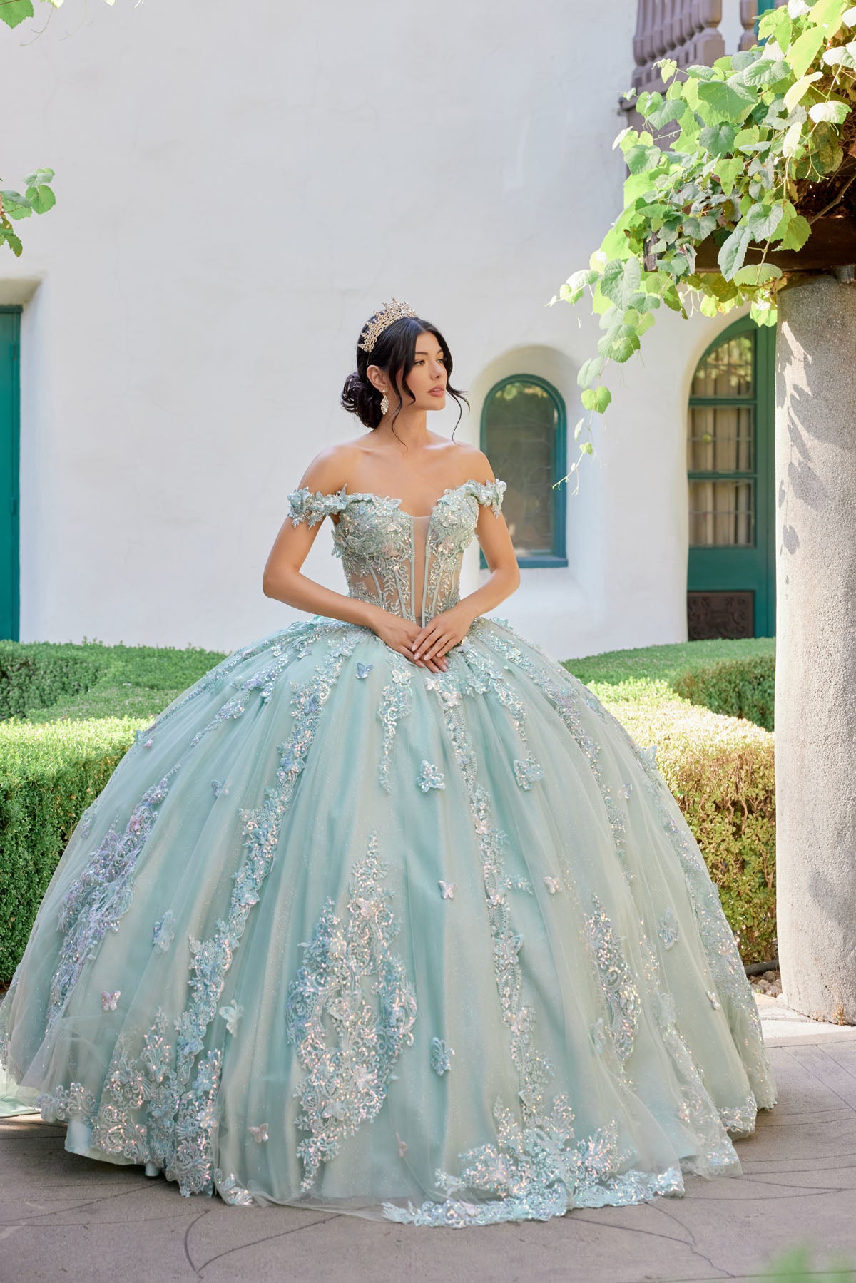 Off-shoulder corset bodice adorned with ornate embroidery and shimmering appliqués.