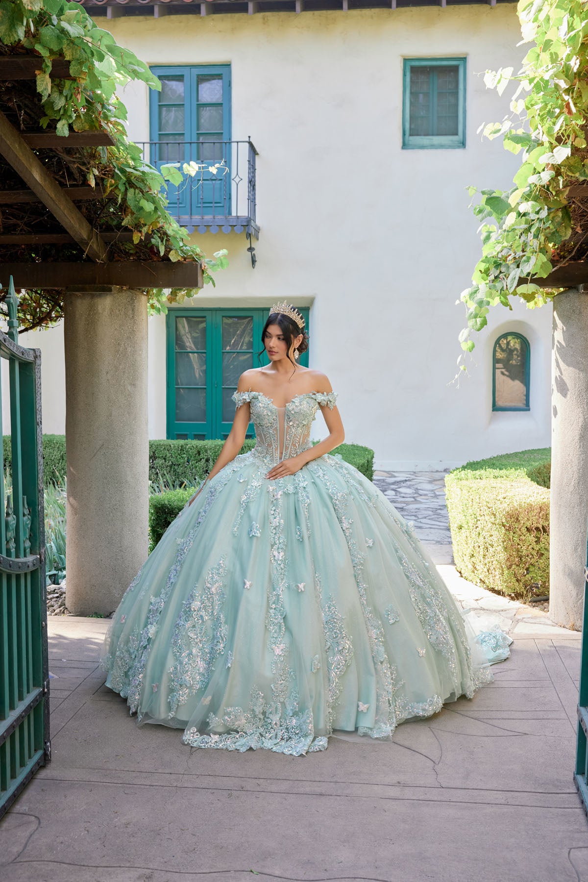 Off-shoulder corset bodice adorned with ornate embroidery and shimmering appliqués.