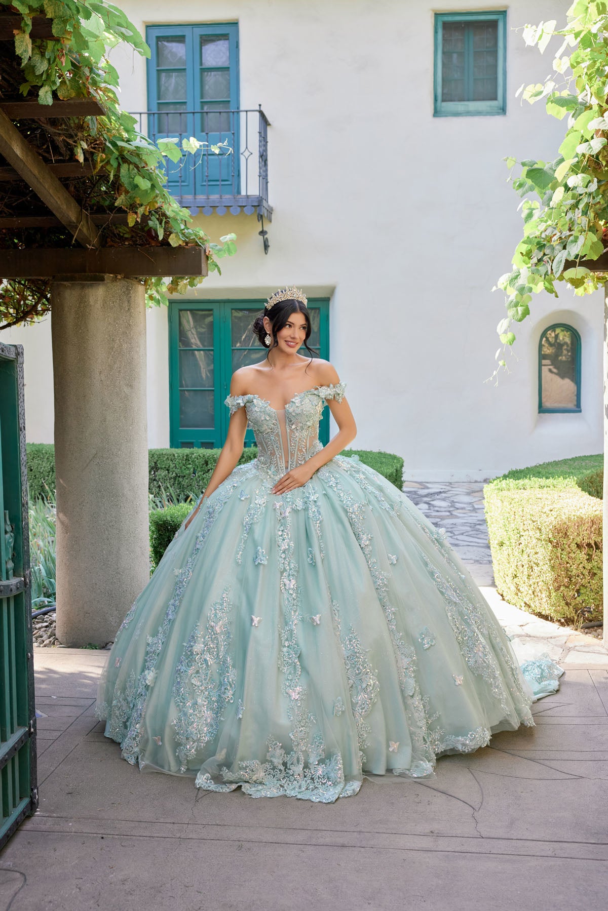 Off-shoulder corset bodice adorned with ornate embroidery and shimmering appliqués.